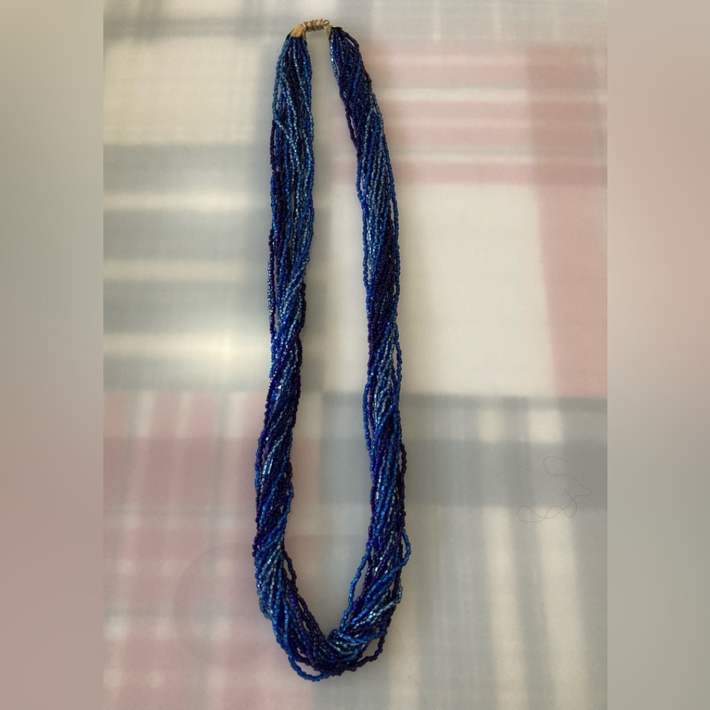 Handmade vintage beaded necklace in different shades of blue and violet.